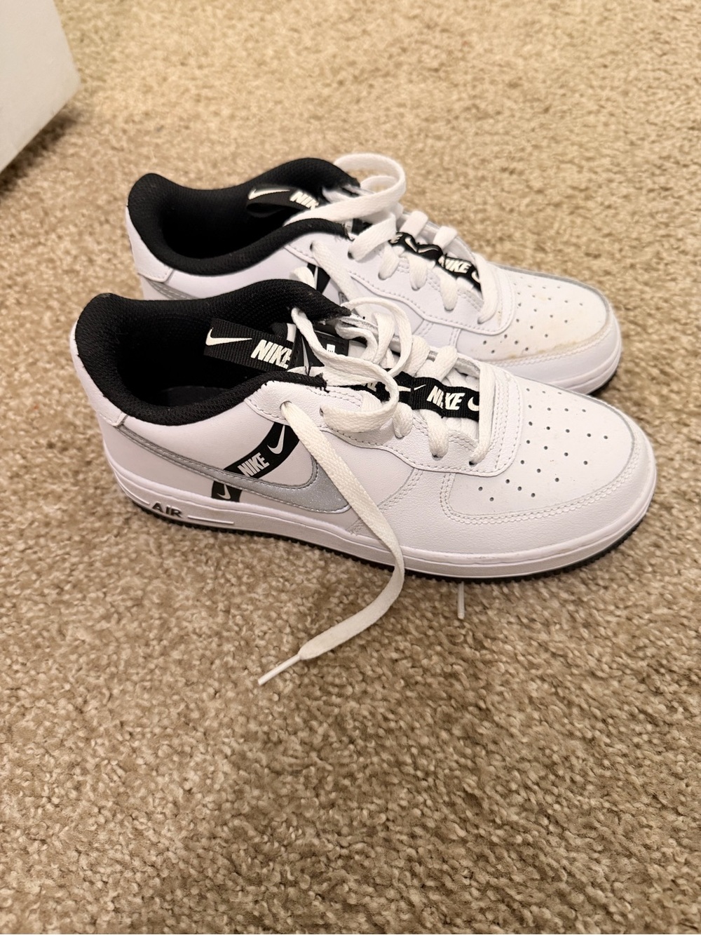 Nike Kids White and Black Low-Top Sneakers with Silver Swoosh